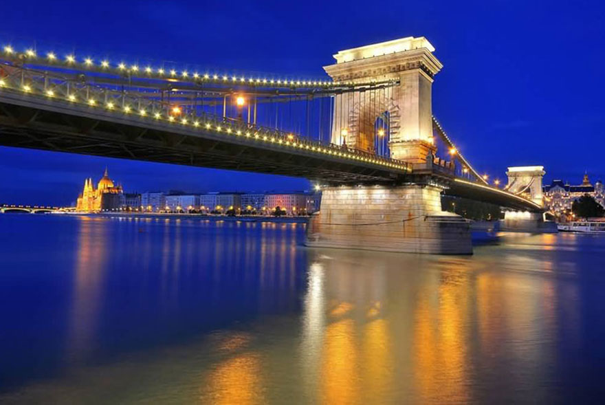 Széchenyi Chain Bridge at night in front of Hungarian Parliament Building, Budapest | View Itinerary